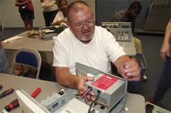 Man taking a computer apart